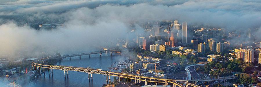 aerial view of Portland, the downtown skyscrapers peaking out of clouds